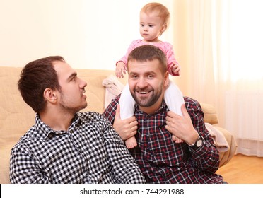 Male Gay Couple With Adopted Baby Girl At Home