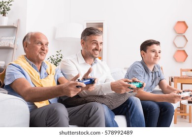 Male generations playing game together at home - Powered by Shutterstock