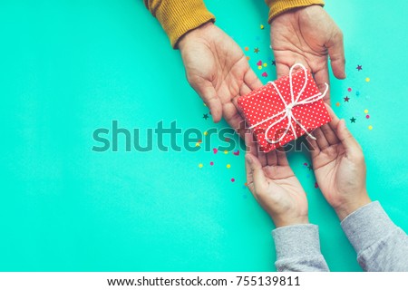Male gives a gift to female with copy space background.happiness moment concepts ideas