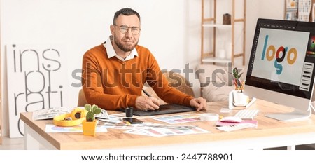 Male graphic designer creating logotype in office