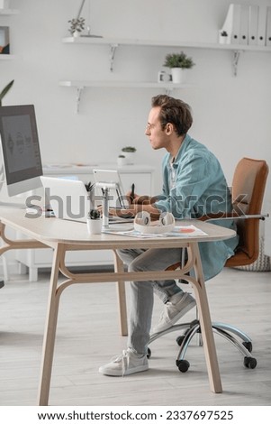 Male graphic designer developing logotype in office