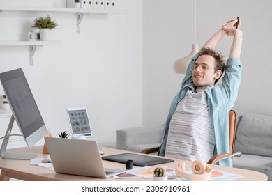 Male graphic designer relaxing in office - Powered by Shutterstock