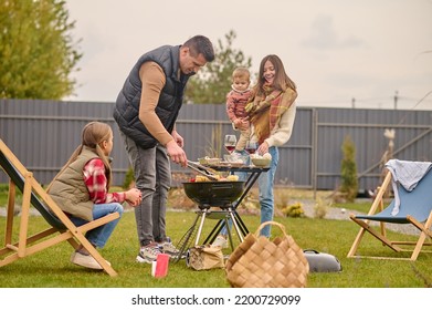 Male grilling vegetables on the grill for the whole family - Shutterstock ID 2200729099