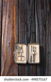 Male Grooming On A Luxury Wooden Background. Travel Nail Trimming Kit. Vertical Top View With Copy Space.