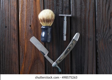 Male Grooming On A Luxury Wooden Background. Mens Safety Razor And Straight Razor With Brush For Shaving. Top View.