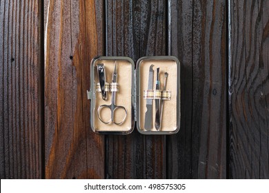 Male Grooming On A Luxury Wooden Background. Travel Nail Trimming Kit. Top View With Copy Space.