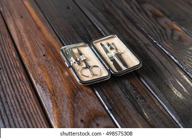 Male Grooming On A Luxury Wooden Background. Travel Nail Trimming Kit With Copy Space.