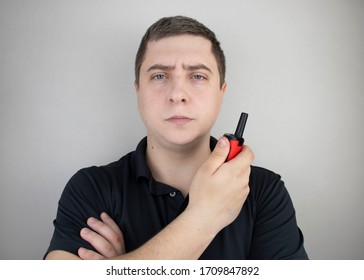 A Male Guard Talking On A Walkie-talkie With His Partner. A Policeman Takes Up The Challenge Of Public Safety. Safety And Security Concept