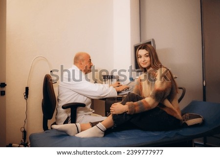 Similar – Carer wearing slippers to elderly female patient