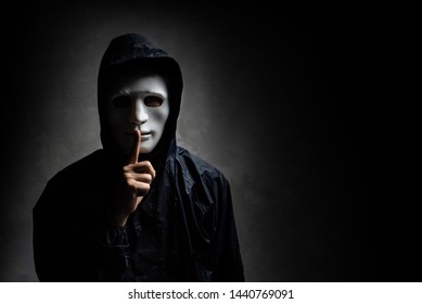 Male Hacker Hidden Face With The Mask In The Dark. Technology, Cyber Crime Concept.