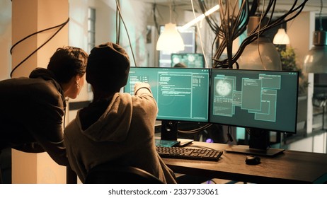Male hacker using knowledge of computer science to access important data illegally, breaking into network system or server. Thief doing cryptojacking and espionage with virus.