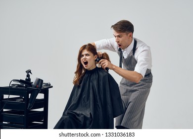 Male Hairdresser Doing Haircut To Woman Beauty Salon Gray Background