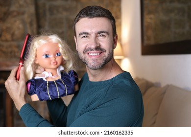 Male Hairstylist Practicing With Doll