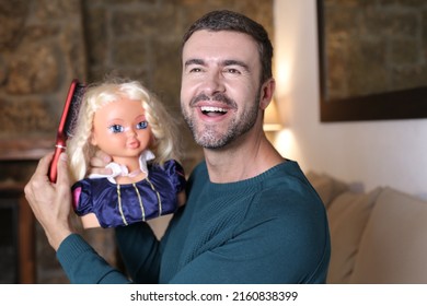 Male Hairstylist Practicing With Doll