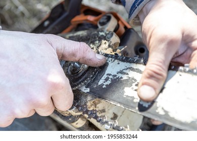 male hand adjusts the gear in the chainsaw, close-up, selective focus - Powered by Shutterstock