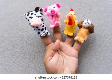 Male Hand With Animal Finger Puppets.