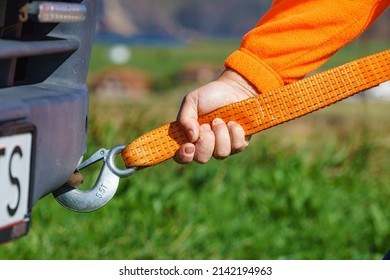 Male Hand Clings Towing Rope Strap To Tow Hook In Caravan Car.