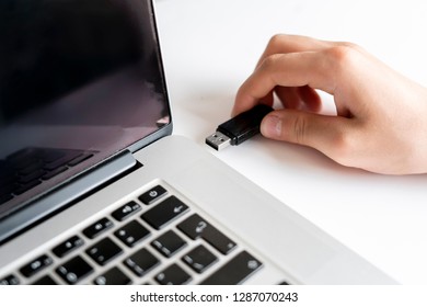 male hand connect usb flash drive in a laptop device - Shutterstock ID 1287070243