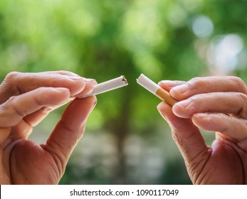 Male Hand Crushing Cigarette On Bokeh Background, Concept Quitting Smoking,World No Tobacco Day.