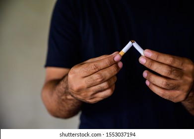 Male Hand Crushing Cigarette. Stop Smoking Concept