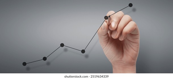 Male hand drawing graph chart showing business profit growth increasing to future - Powered by Shutterstock