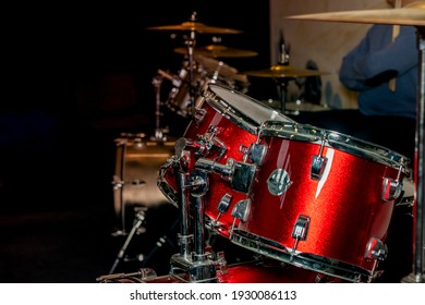 Male hand and drums with metal plates.