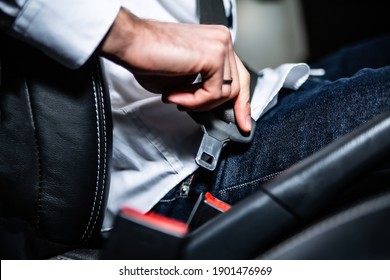 A Male Hand Fastening The Seat Belt, Safety Belt In A Car Driver's Seat. Responsible And Safe Car Driving.