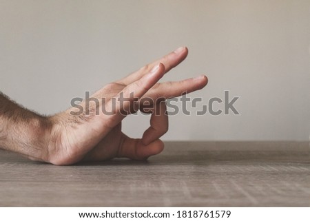 Male hand flicking on a table