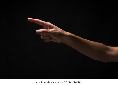 Male Hand, Forefinger Pointing Away. Hand Gestures - Man Indicating On Virtual Object With Index Finger, Isolated On Black Background, Copy Space