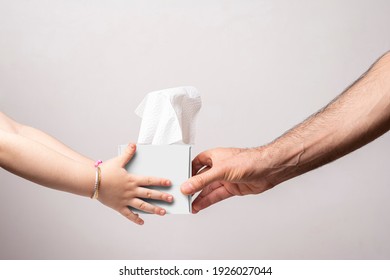 Male hand giving a cubical tissue box to little girl isolated white background, editable mock-up series template ready for your design, faces selection path icluded.