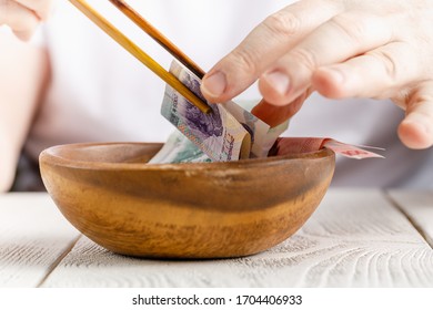 Male Hand Hold Chinese Yuan Or Abbreviated RMB Banknote, The Official Currency Of The Peoples Republic Of China