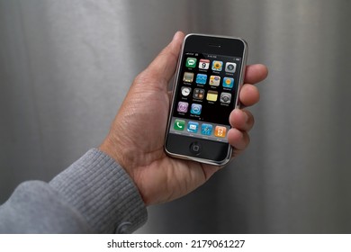 A Male Hand Holding A 1st Generation IPhone With The Main Display Turned On In Landscape Layout. Originally Released June 2007. July 16, 2022. San Francisco, CA.