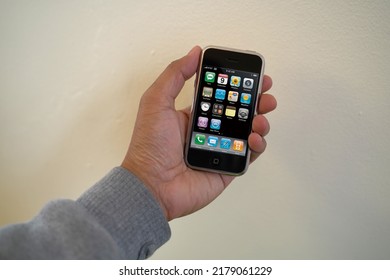 A Male Hand Holding A 1st Generation IPhone With The Main Display Turned On In Landscape Layout. Originally Released June 2007. July 16, 2022. San Francisco, CA.