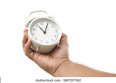 Male Hand Holding Alarm Clock On White Background