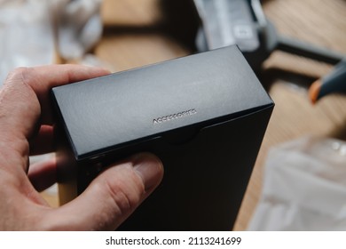 Male Hand Holding Black Luxury Box With Text Accesories After Unboxing New Tech Product - Drone, Pc, Phone, Tablet