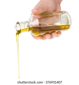 Male Hand Holding A Bottle. Oil Pouring From A Bottle.  