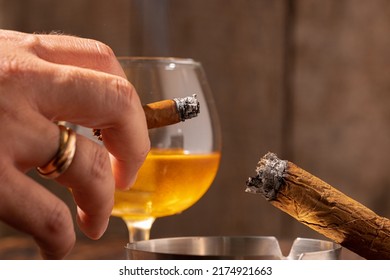 Male Hand Holding Burning Cigar Close Up