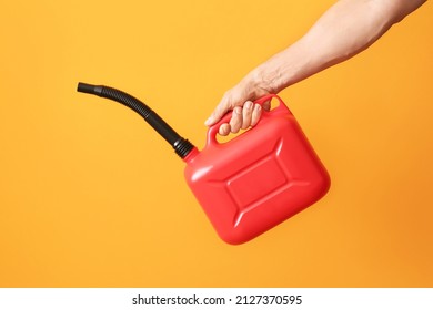 Male hand holding canister with rubber nozzle on color background