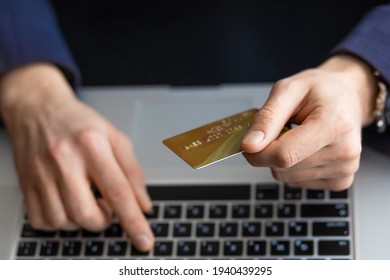 Male hand holding credit bank card and using laptop. Online Payment, Purchase, shopping, e-commerce, internet banking, spending money, Entering Transaction, business.