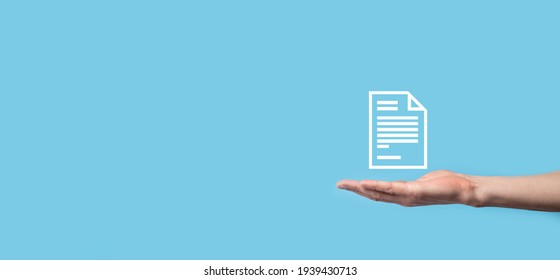 Male Hand Holding A Document Icon On Blue Background. Document Management Data System Business Internet Technology Concept. Corporate Data Management System DMS.