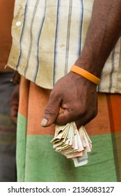 Male Hand Holding Folded Banknotes