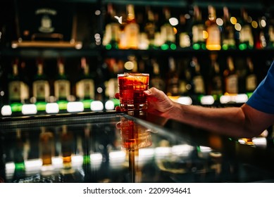 Male Hand Holding A Glass Of Whiskey Coktail In A Bar