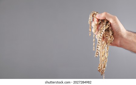 Male Hand Holding Gold Jewelry. 