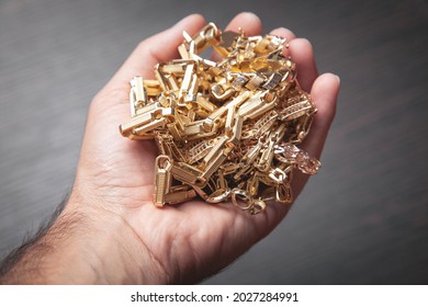 Male Hand Holding Gold Jewelry. 