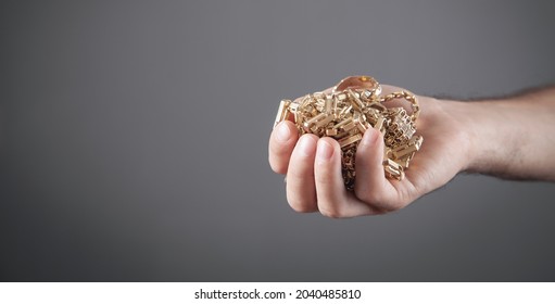 Male Hand Holding Gold Jewelry. 