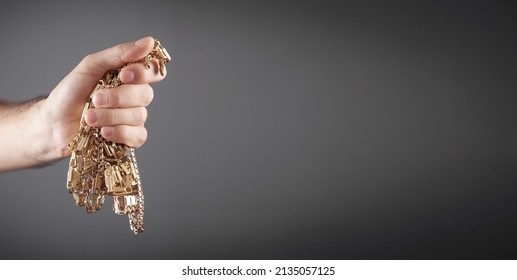 Male Hand Holding Gold Jewelry. 