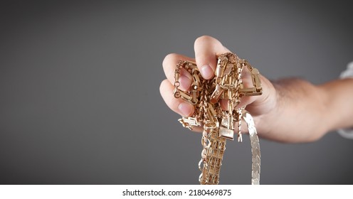 Male Hand Holding Gold Jewelry. 