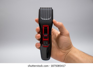 Male Hand Holding Hair Clipper.