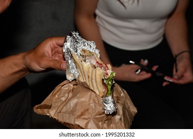 Male Hand Holding A Half Eaten Sandwich