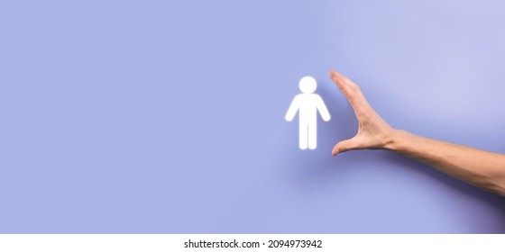 Male Hand Holding Human Icon On Blue Background. Human Resources HR Management Recruitment Employment Headhunting Concept.Select Team Leader Concept. Male Hand Click On Man Icon.Banner ,copy Spase